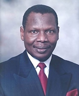 H.E Alexander Amani Muganda                                    - High Commissioner